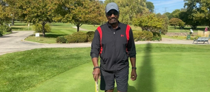 A male proton center patient standing on a sunny golf course and looking at the camera.